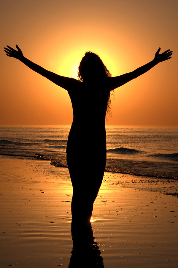 bgWomanBeachSunsetLeft-vertical